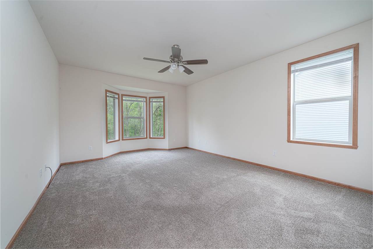 9909 Lismore Road Roscoe, IL 61073 - Photo 13 of 24 an empty room with windows and fan