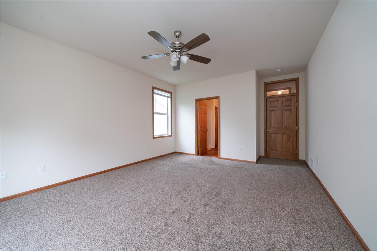 9909 Lismore Road Roscoe, IL 61073 - Photo 14 of 24 a view of a livingroom with a ceiling fan and window