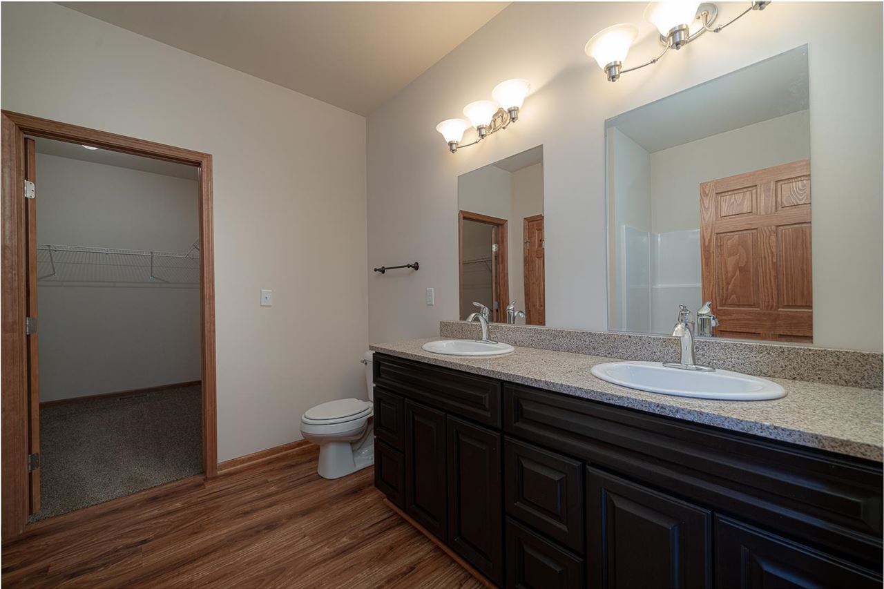 9909 Lismore Road Roscoe, IL 61073 - Photo 15 of 24 a bathroom with a double vanity sink and a mirror