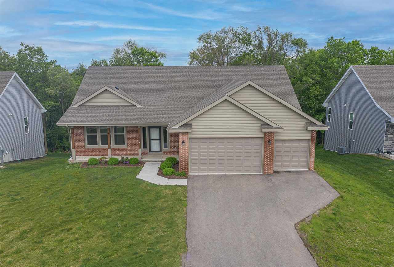 9909 Lismore Road Roscoe, IL 61073 - Photo 2 of 24 a front view of a house with a yard and garage