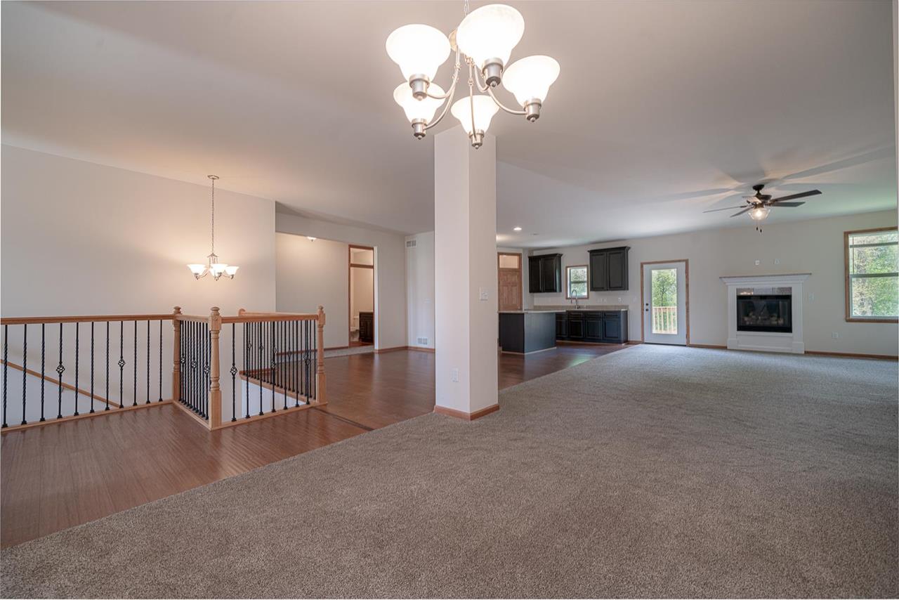 9909 Lismore Road Roscoe, IL 61073 - Photo 6 of 24 a view of a livingroom with a chandelier fan