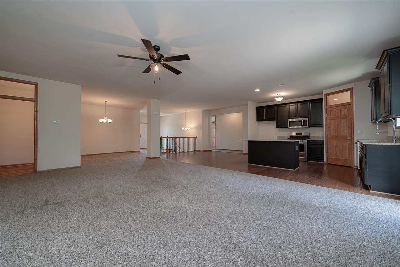 9909 Lismore Road Roscoe, IL 61073 - Photo 7 of 24 a view of a kitchen with a sink and a ceiling fan
