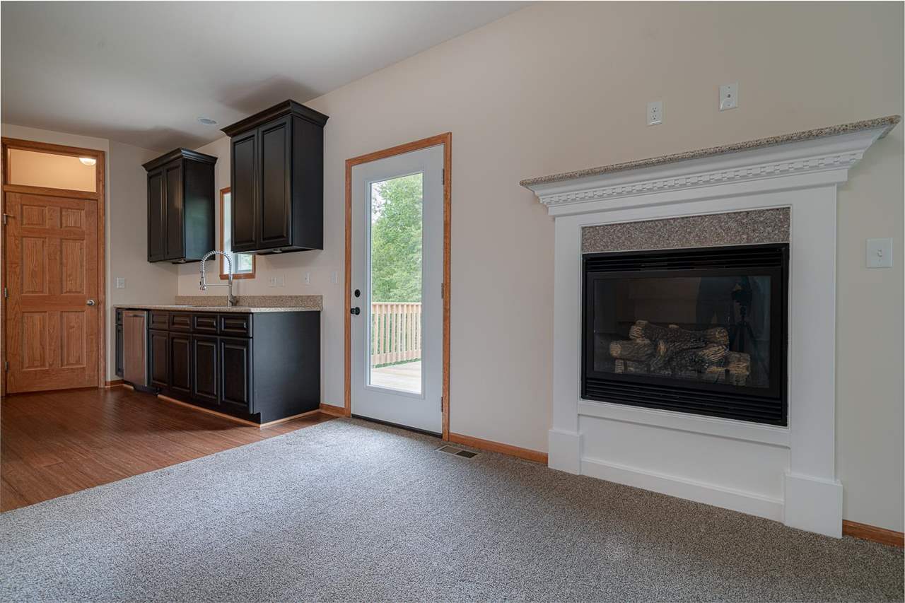 9909 Lismore Road Roscoe, IL 61073 - Photo 8 of 24 a room with furniture and a fireplace