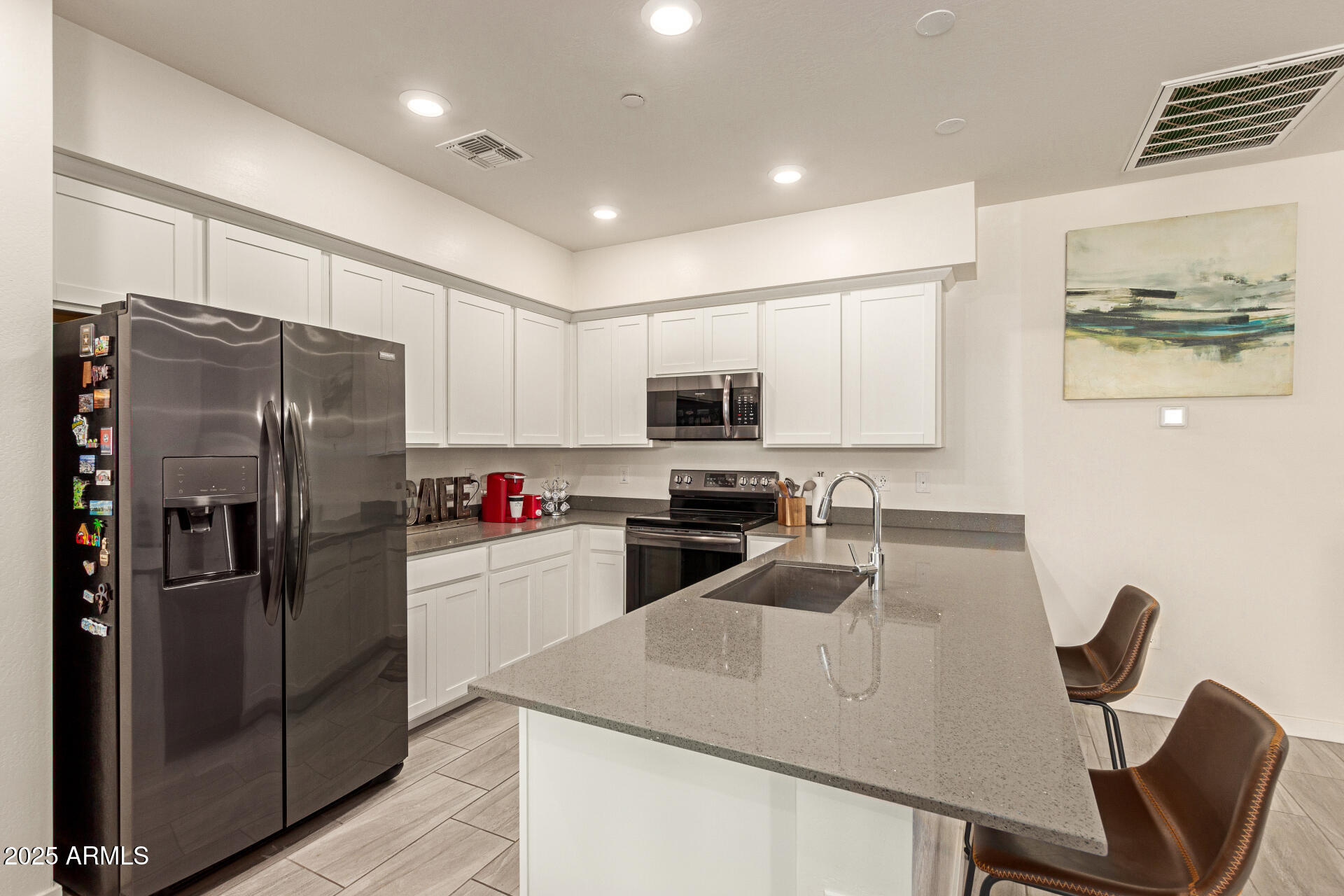 1851 East Frye Road, Unit 101 Gilbert, AZ 85295 - Photo 11 of 37 a kitchen with a refrigerator a stove a sink and chairs
