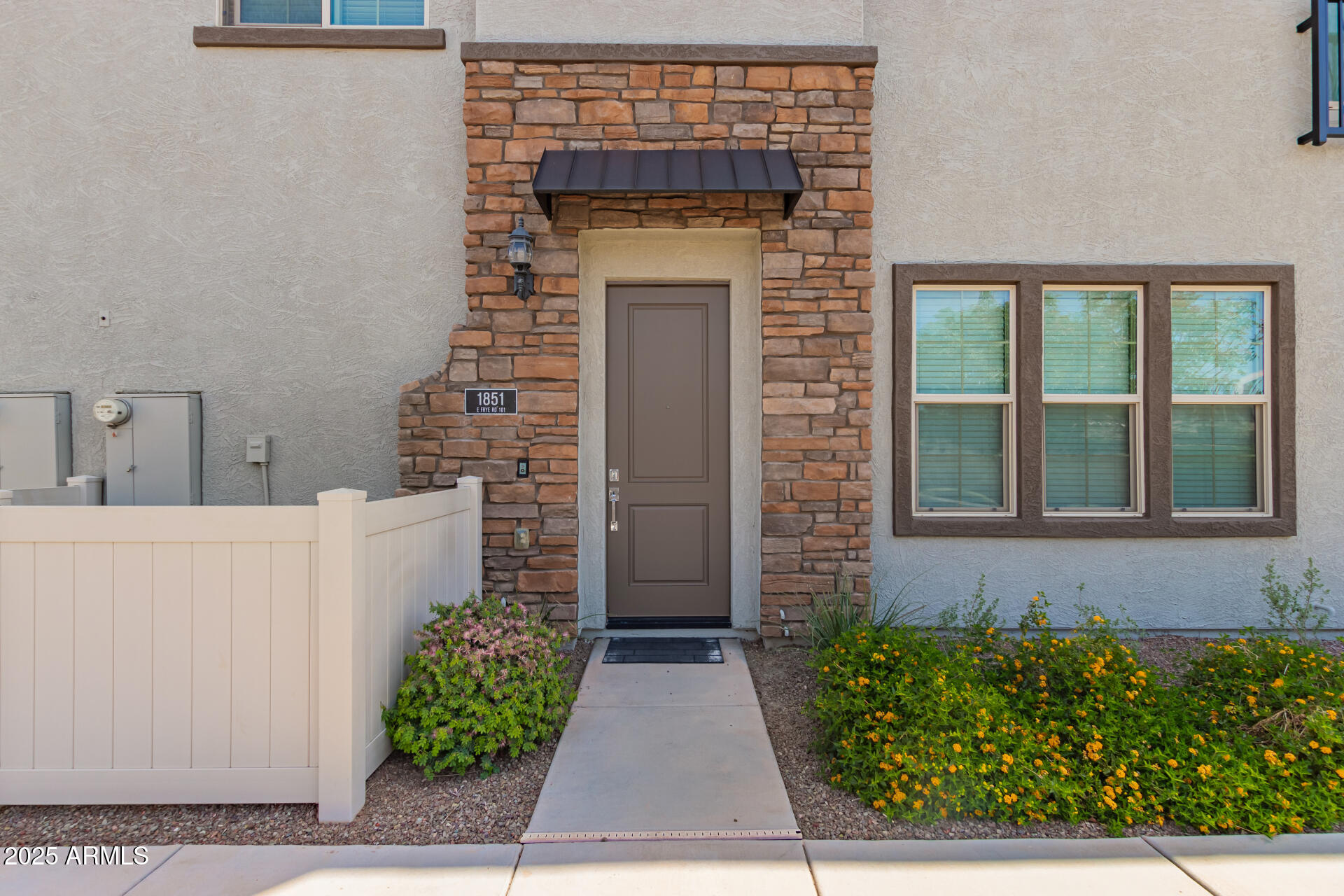 1851 East Frye Road, Unit 101 Gilbert, AZ 85295 - Photo 3 of 37 a stone house with a outdoor space