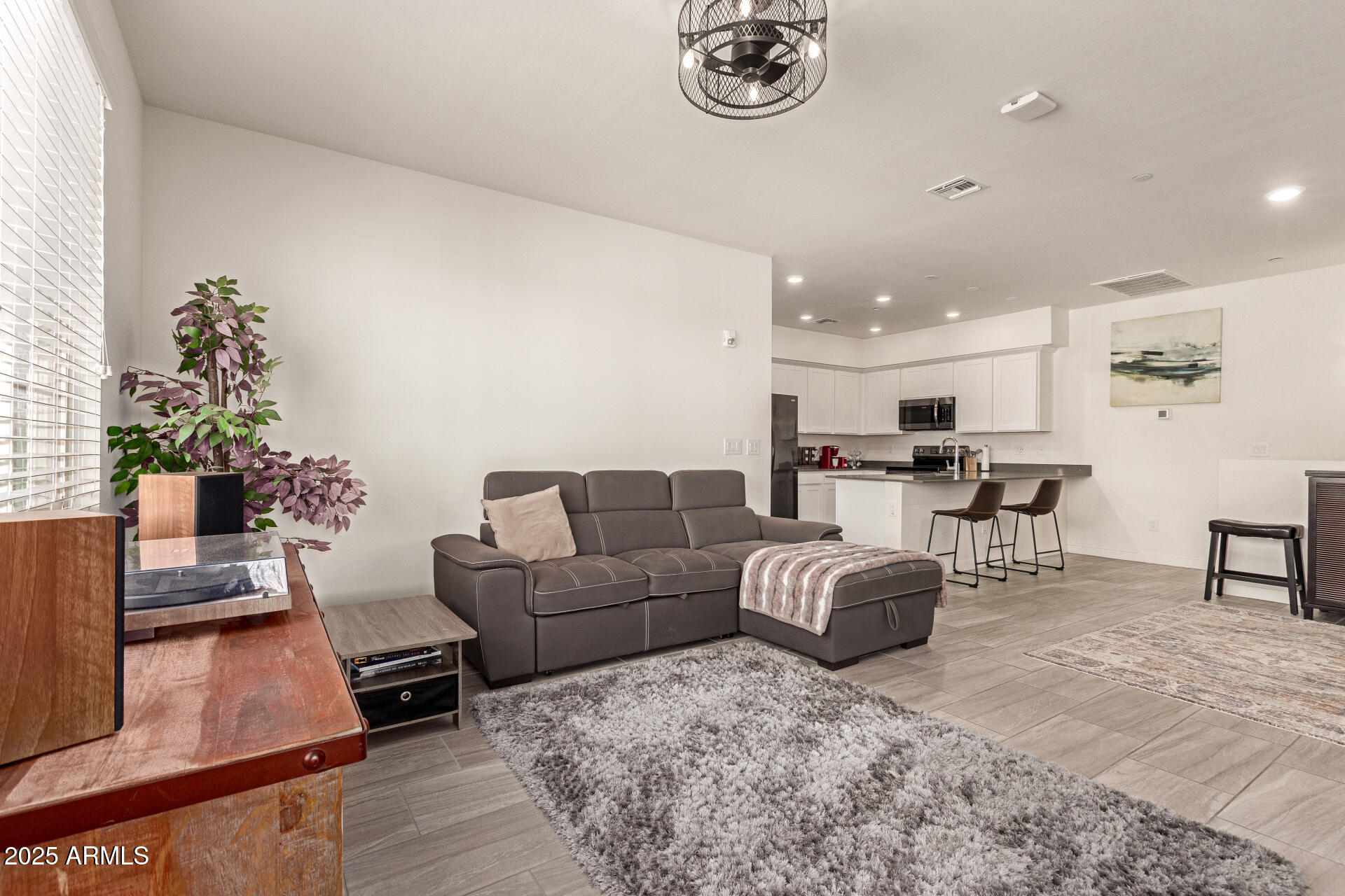 1851 East Frye Road, Unit 101 Gilbert, AZ 85295 - Photo 9 of 37 a living room with furniture and a dining table with potted plant