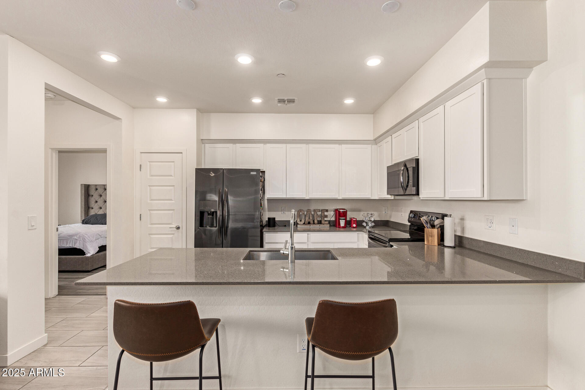1851 East Frye Road, Unit 101 Gilbert, AZ 85295 - Photo 10 of 37 a kitchen with stainless steel appliances granite countertop a sink and a refrigerator