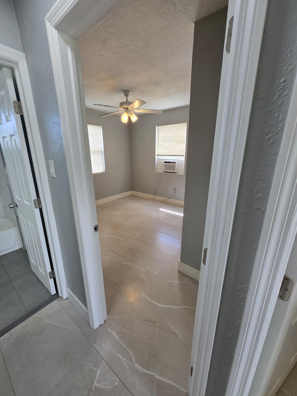 1015 Southwest 8th Street, Unit 1 Miami, FL 33130 - Photo 4 of 7 a view of a hallway with windows and chandelier