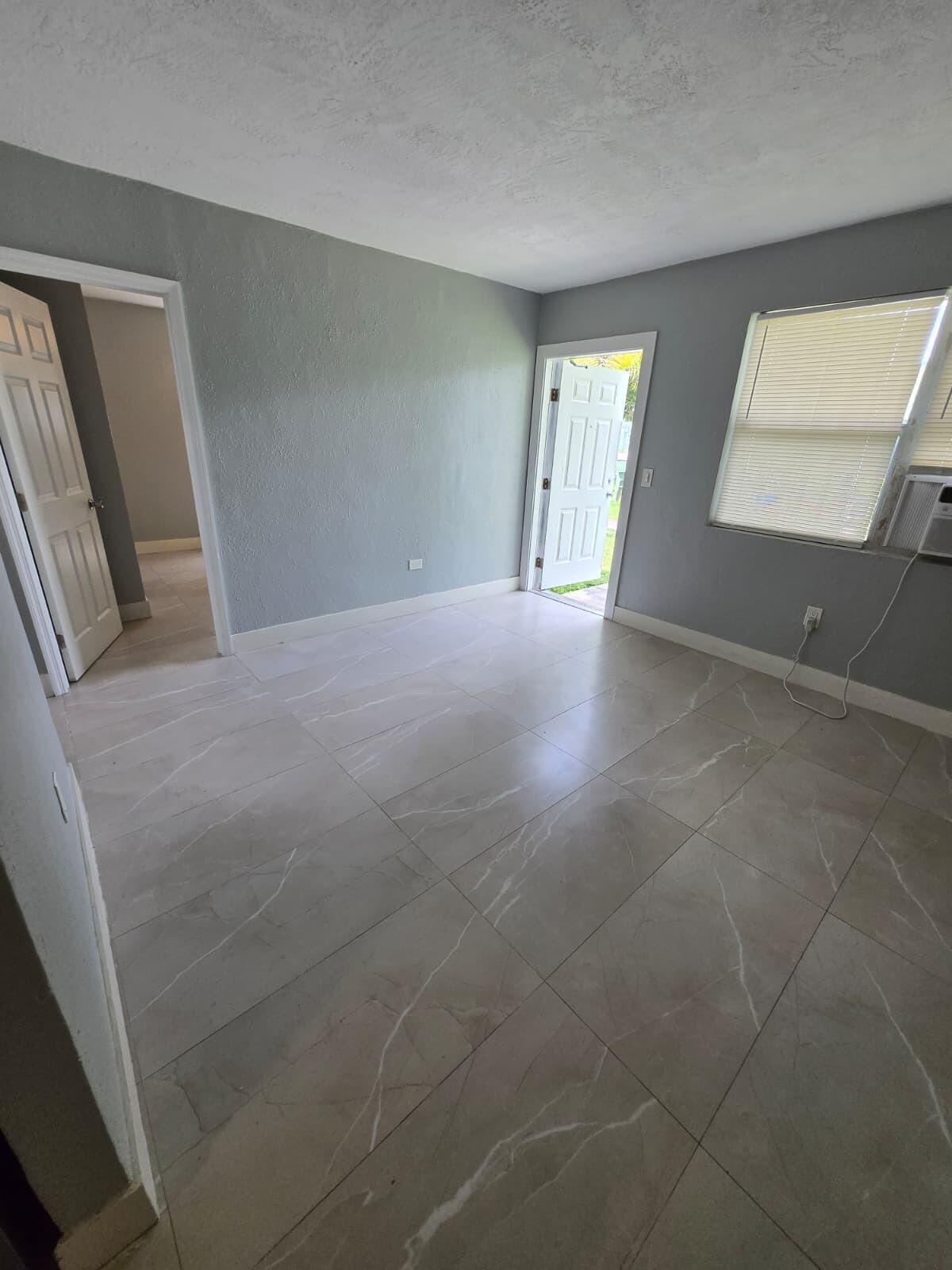 1015 Southwest 8th Street, Unit 1 Miami, FL 33130 - Photo 6 of 7 a view of an empty room and window