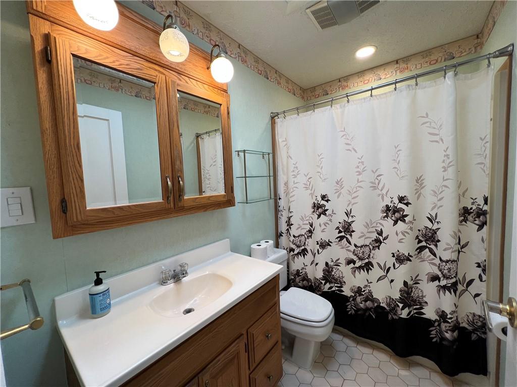 203 Carson Street Springdale, PA 15144 - Photo 14 of 43 a bathroom with a sink toilet and shower