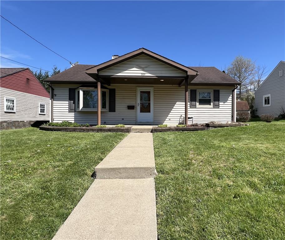 203 Carson Street Springdale, PA 15144 - Photo 2 of 43 a front view of a house with a yard and garage