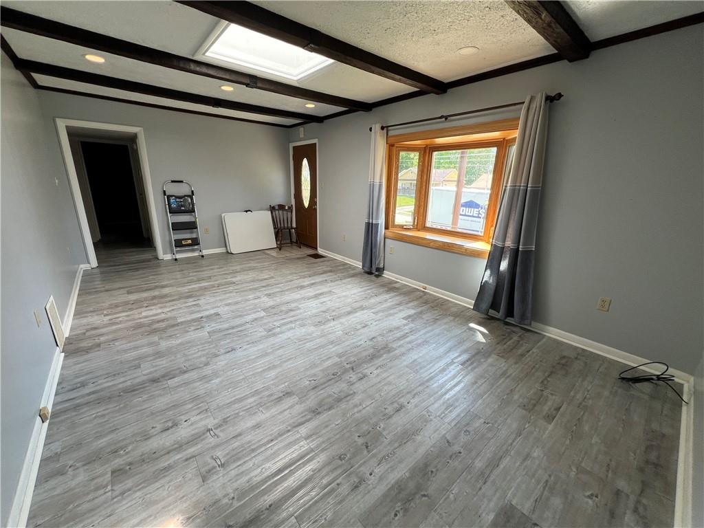 203 Carson Street Springdale, PA 15144 - Photo 6 of 43 a view of an empty room with a window and wooden floor