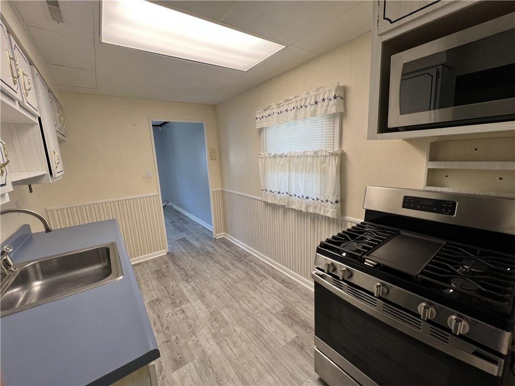 203 Carson Street Springdale, PA 15144 - Photo 10 of 43 a kitchen with granite countertop a stove and a sink