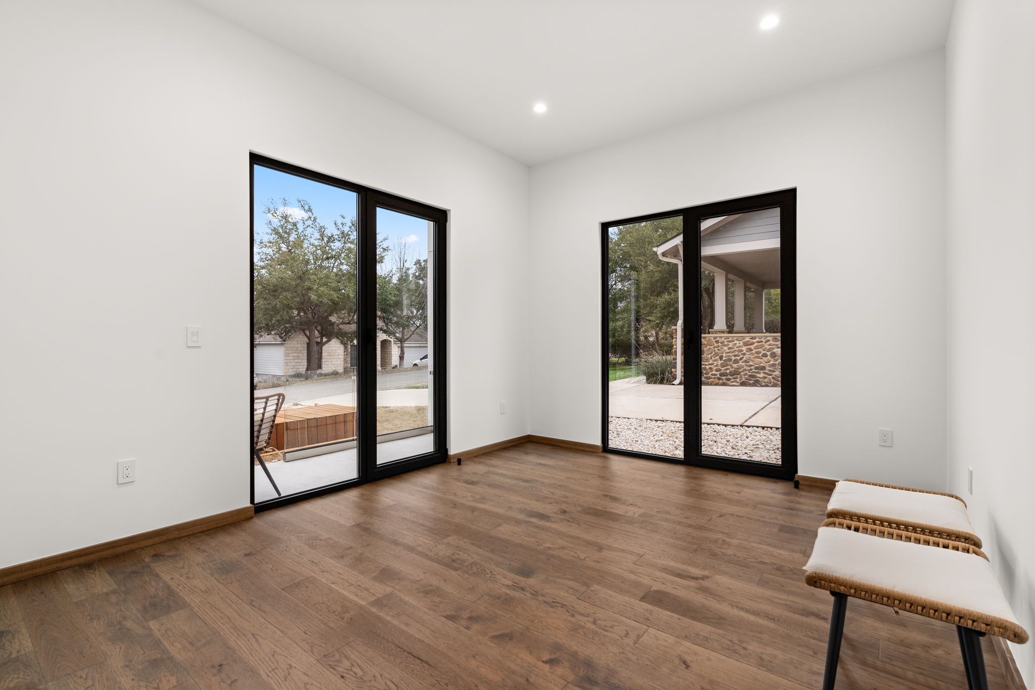 2915 Chisholm Trail Austin, TX 78734 - Photo 7 of 35 an empty room with wooden floor and windows
