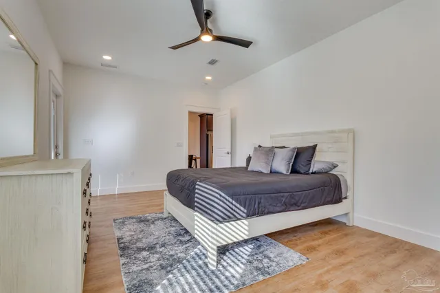 a bedroom with a bed lamp and a fireplace