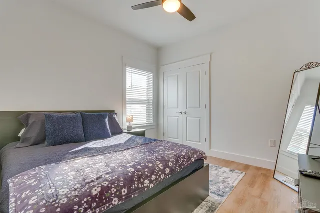 a bedroom with a large bed and a flat tv screen on a dresser