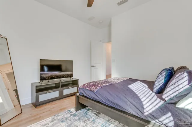 a bedroom with a bed and a television