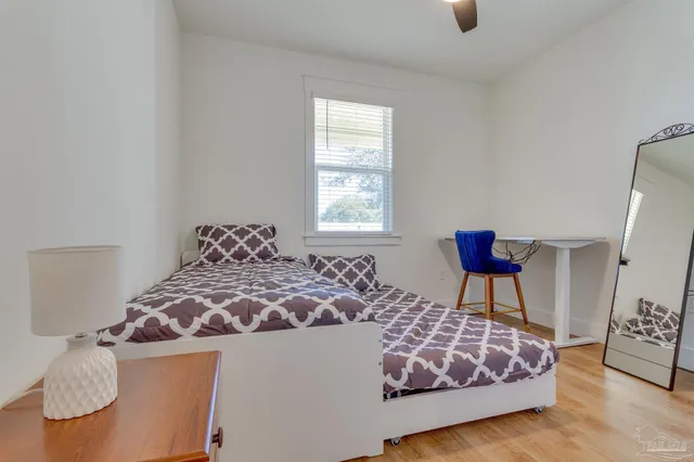 a bedroom with a bed and a dresser in it