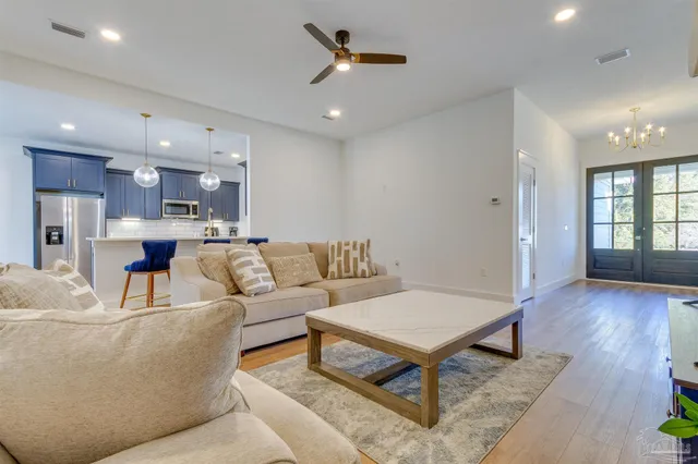 a living room with furniture and a wooden floor