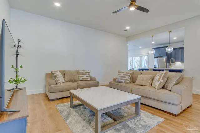 a living room with furniture and a chandelier