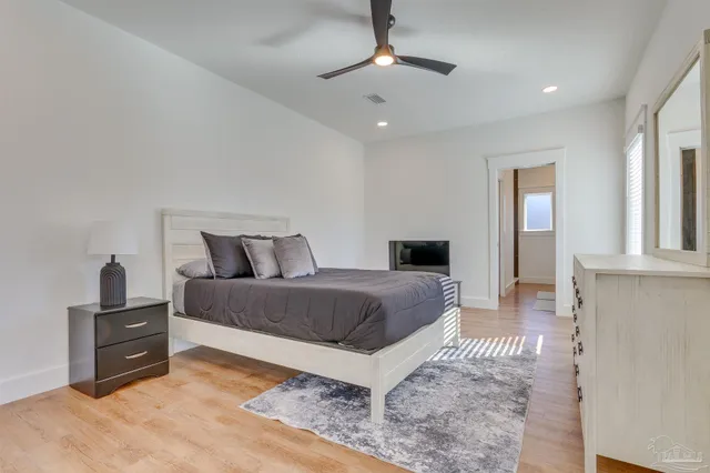 a bedroom with a bed and a chandelier