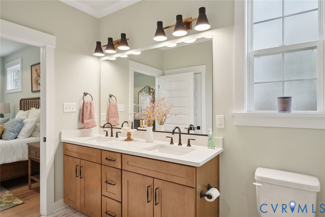 8711 Terroir Lane New Kent, VA 23124 - Photo 15 of 27 a bathroom with a toilet sink and mirror