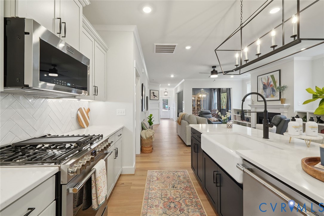 8711 Terroir Lane New Kent, VA 23124 - Photo 3 of 27 a large kitchen with stainless steel appliances granite countertop a lot of counter space and a sink