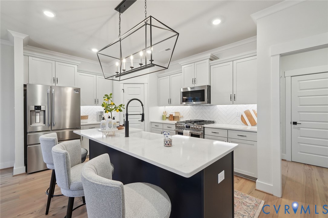 8711 Terroir Lane New Kent, VA 23124 - Photo 7 of 27 a kitchen with refrigerator cabinets and wooden floor