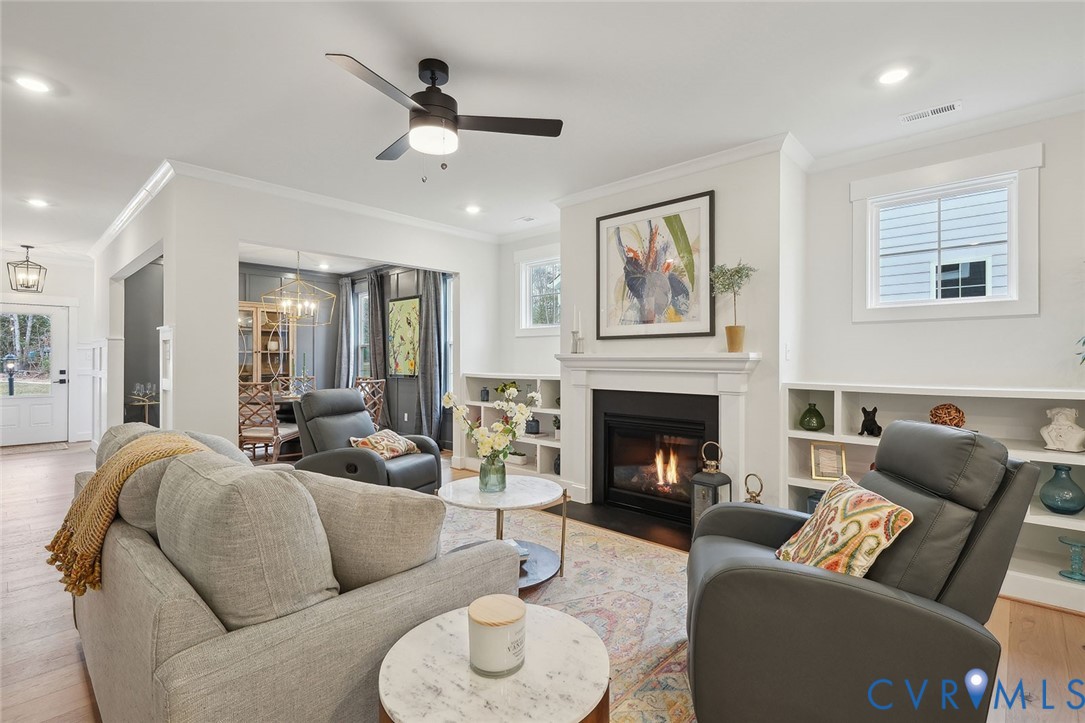8711 Terroir Lane New Kent, VA 23124 - Photo 10 of 27 a living room with furniture a fireplace and a ceiling fan