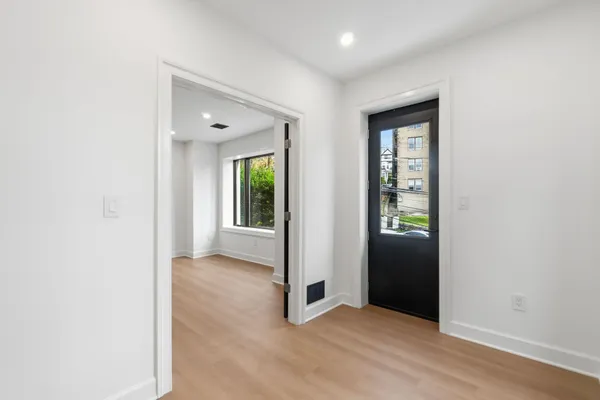 an empty room with windows and closet
