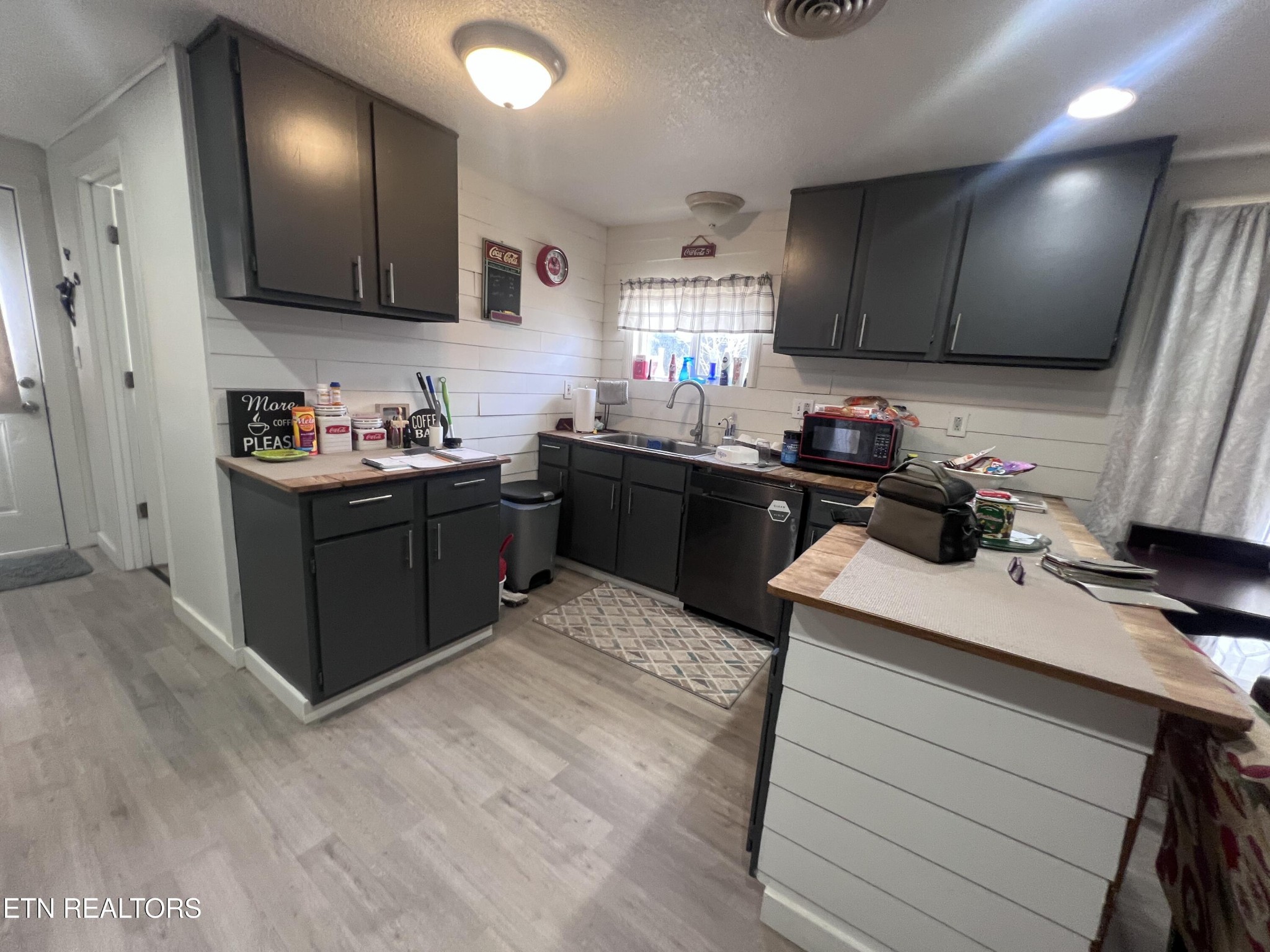 428 Patton Heights Circle Jamestown, TN 38556 - Photo 12 of 29 a kitchen with stainless steel appliances kitchen island granite countertop wooden cabinets a stove top oven a sink and dishwasher
