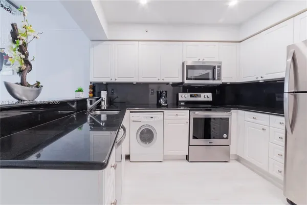 a utility room with sink dryer and washer