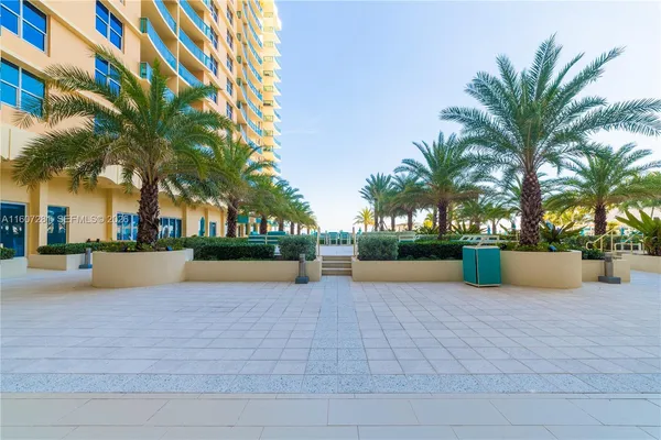 a view of house with swimming pool and sitting area