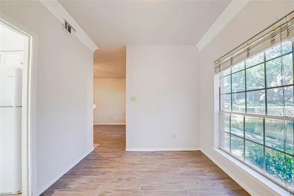 a view of hallway with wooden floor