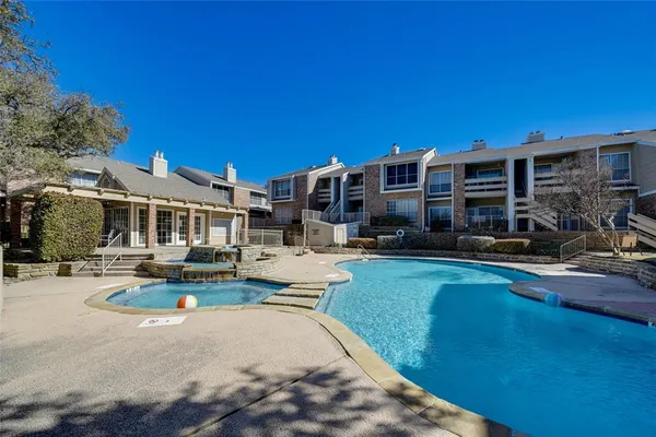 a view of a house with swimming pool and sitting area