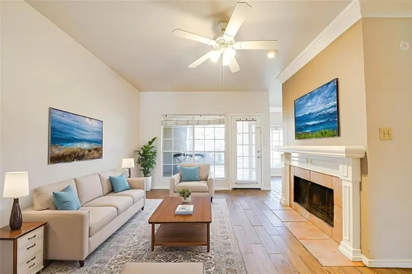 a living room with furniture a fireplace and a flat screen tv