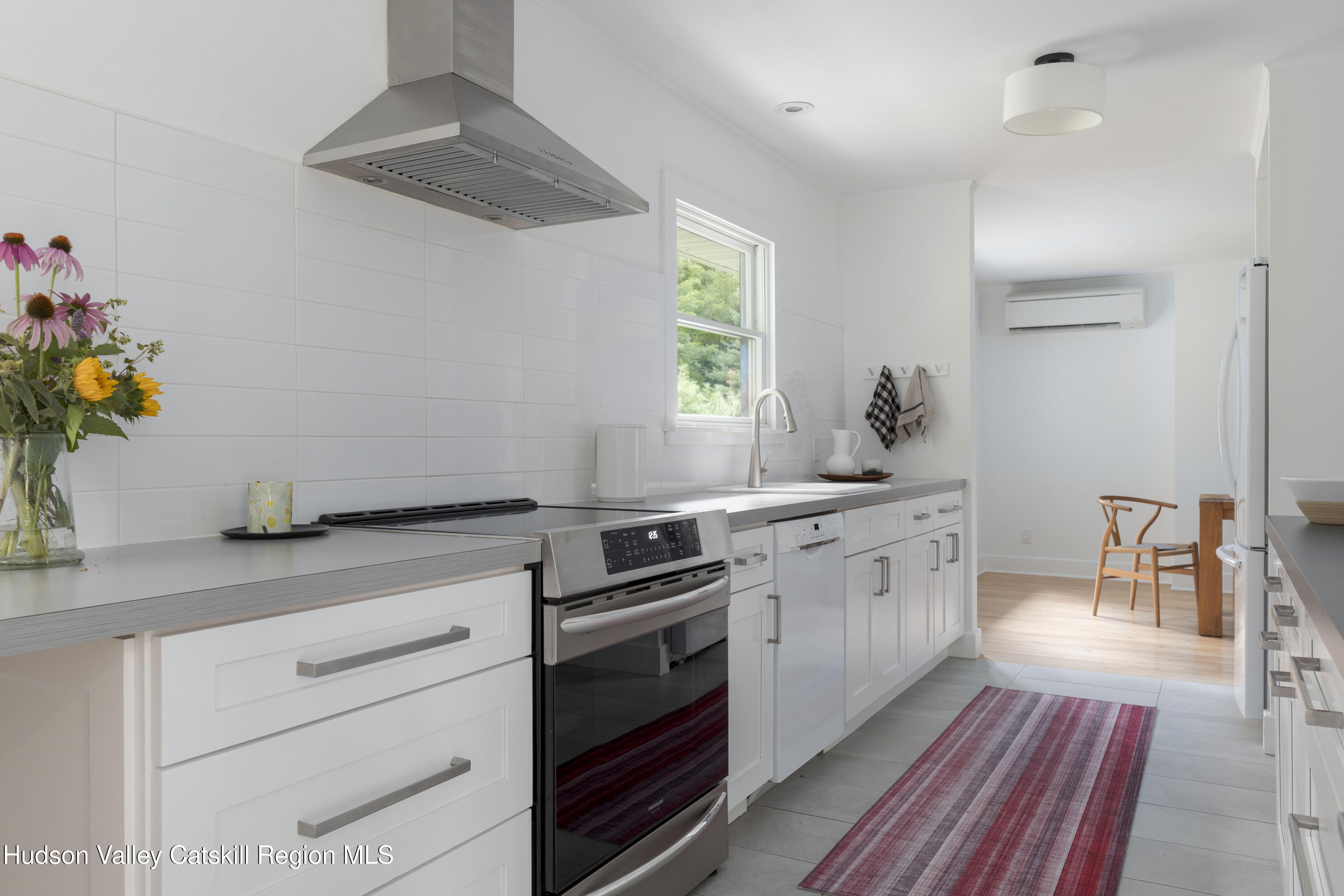 292 County Rte 27B Hudson, NY 12534 - Photo 16 of 40 a kitchen with a stove cabinets and wooden floor