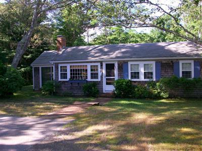 20 Piney Road Cotuit, MA 02635 - Photo 1 of 9 a front view of a house with a yard