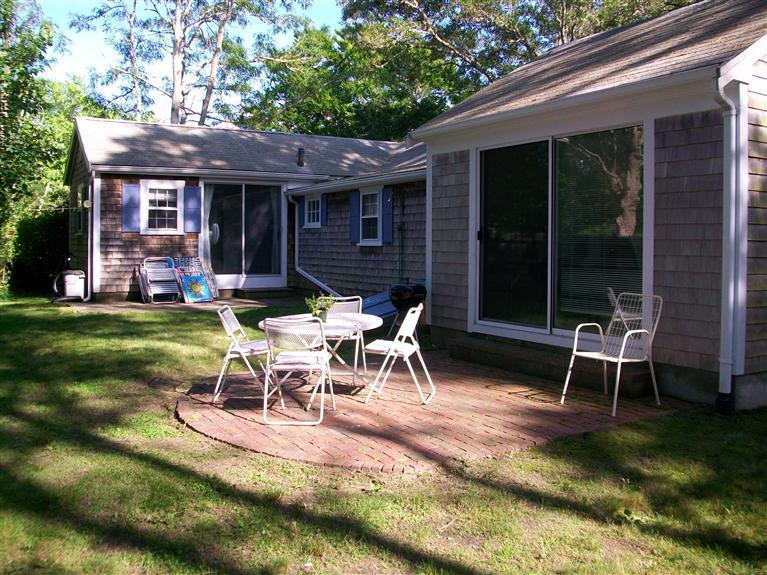 20 Piney Road Cotuit, MA 02635 - Photo 9 of 9 a view of a backyard with table and chairs