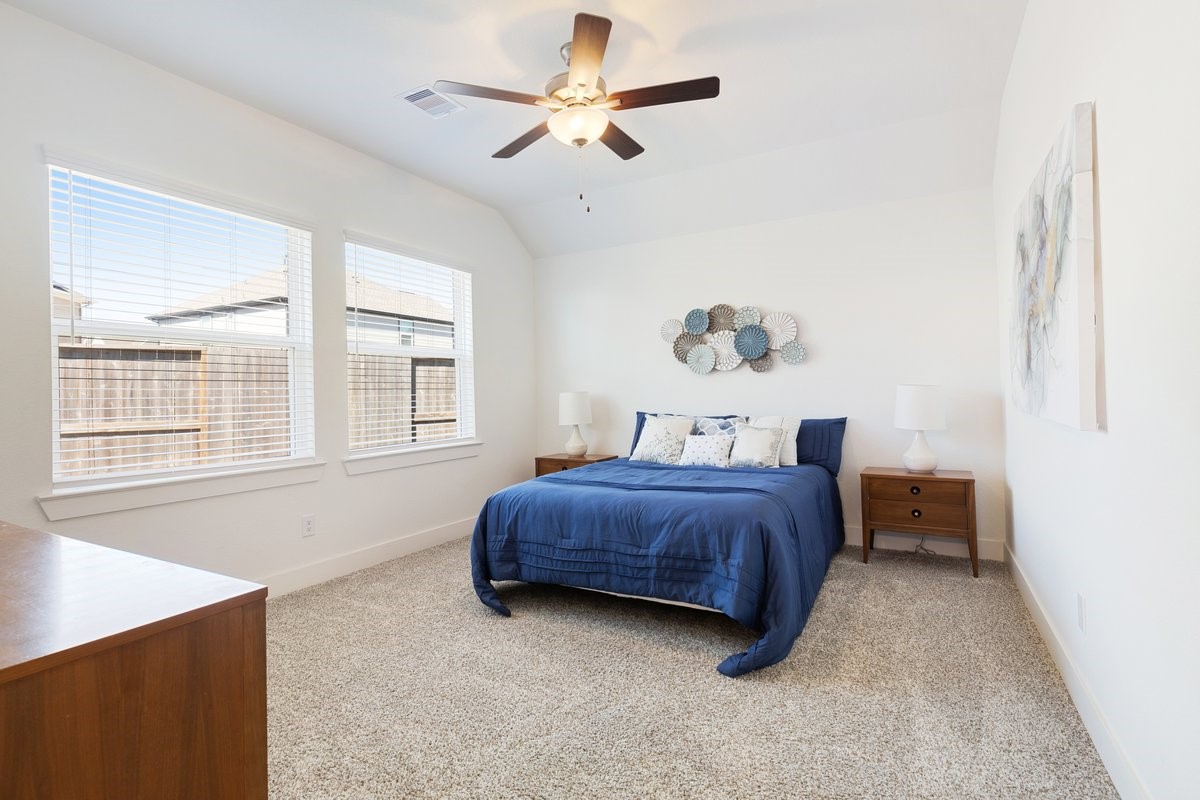 10122 Crescendo Way Manvel, TX 77578 - Photo 10 of 24 a spacious bedroom with a bed dresser and a window