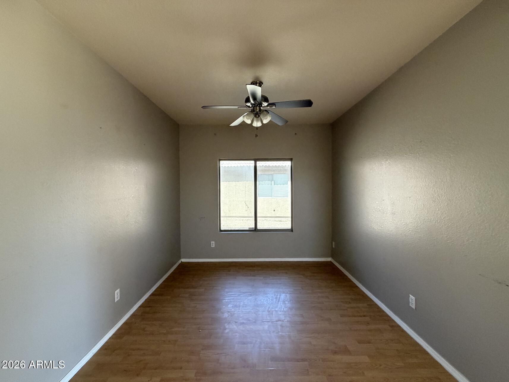 10807 West Monte Vista Road Avondale, AZ 85392 - Photo 13 of 33 an empty room with a window and a ceiling fan