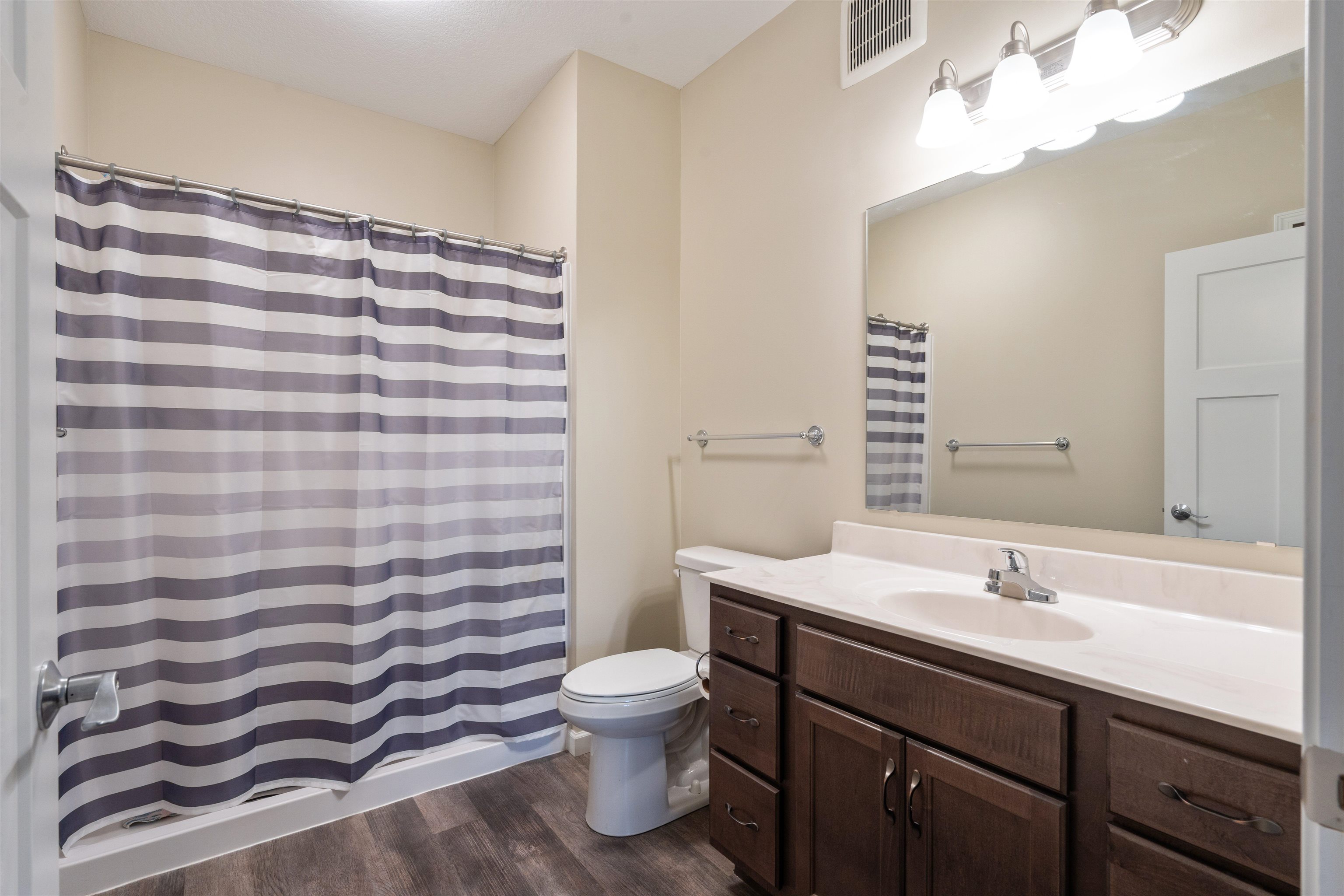 2592 Middle Road, Unit 208 Bettendorf, IA 52722 - Photo 15 of 19 a bathroom with a sink a toilet and mirror