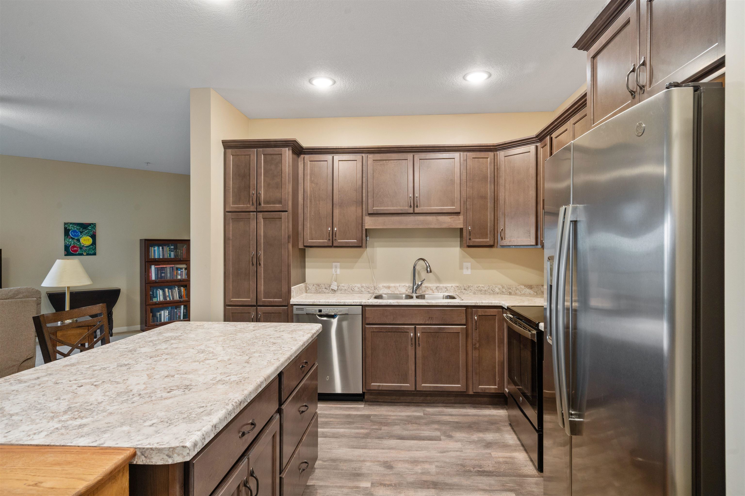 2592 Middle Road, Unit 208 Bettendorf, IA 52722 - Photo 4 of 19 a kitchen with a sink refrigerator and cabinets