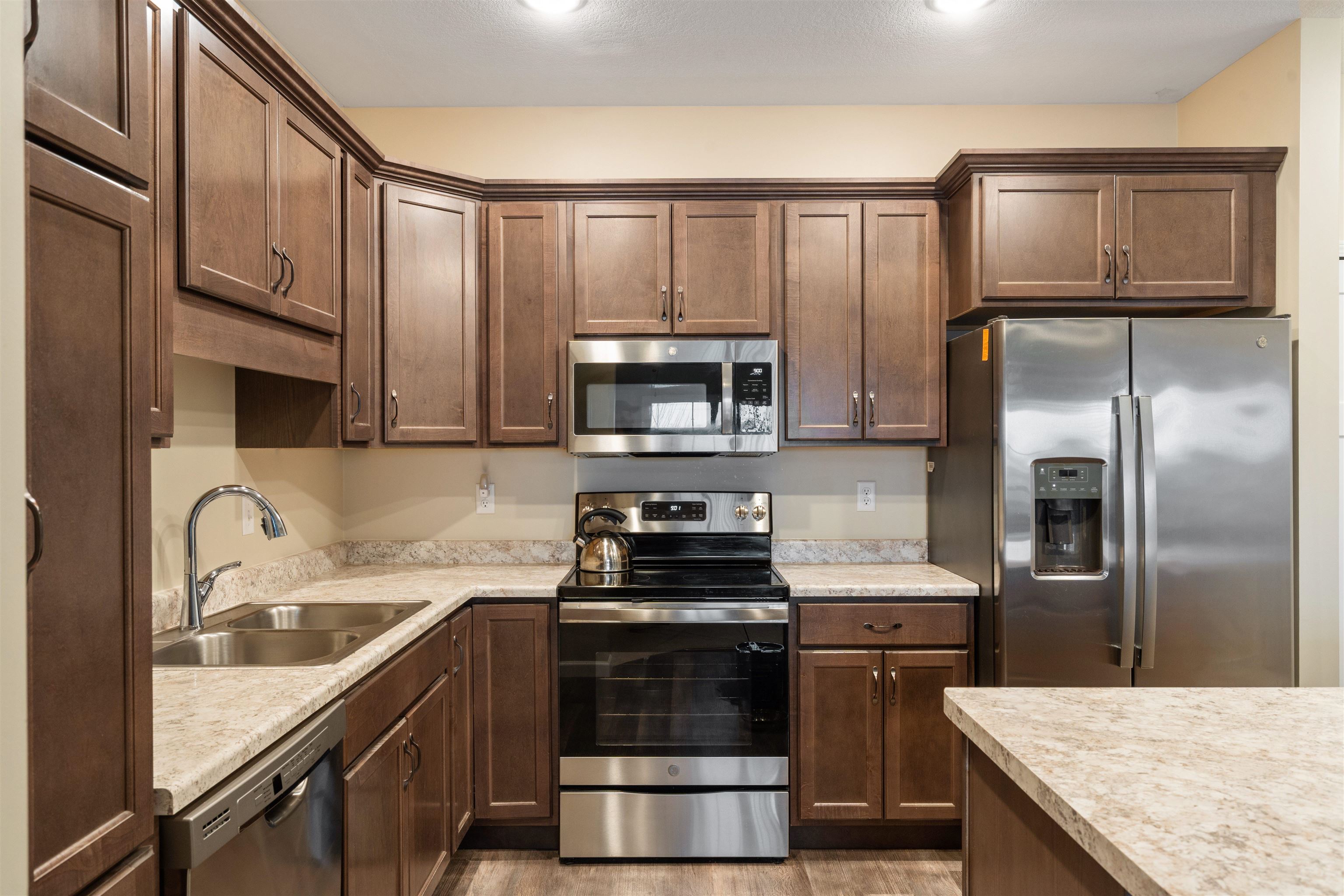 2592 Middle Road, Unit 208 Bettendorf, IA 52722 - Photo 5 of 19 a kitchen with a sink stove and refrigerator