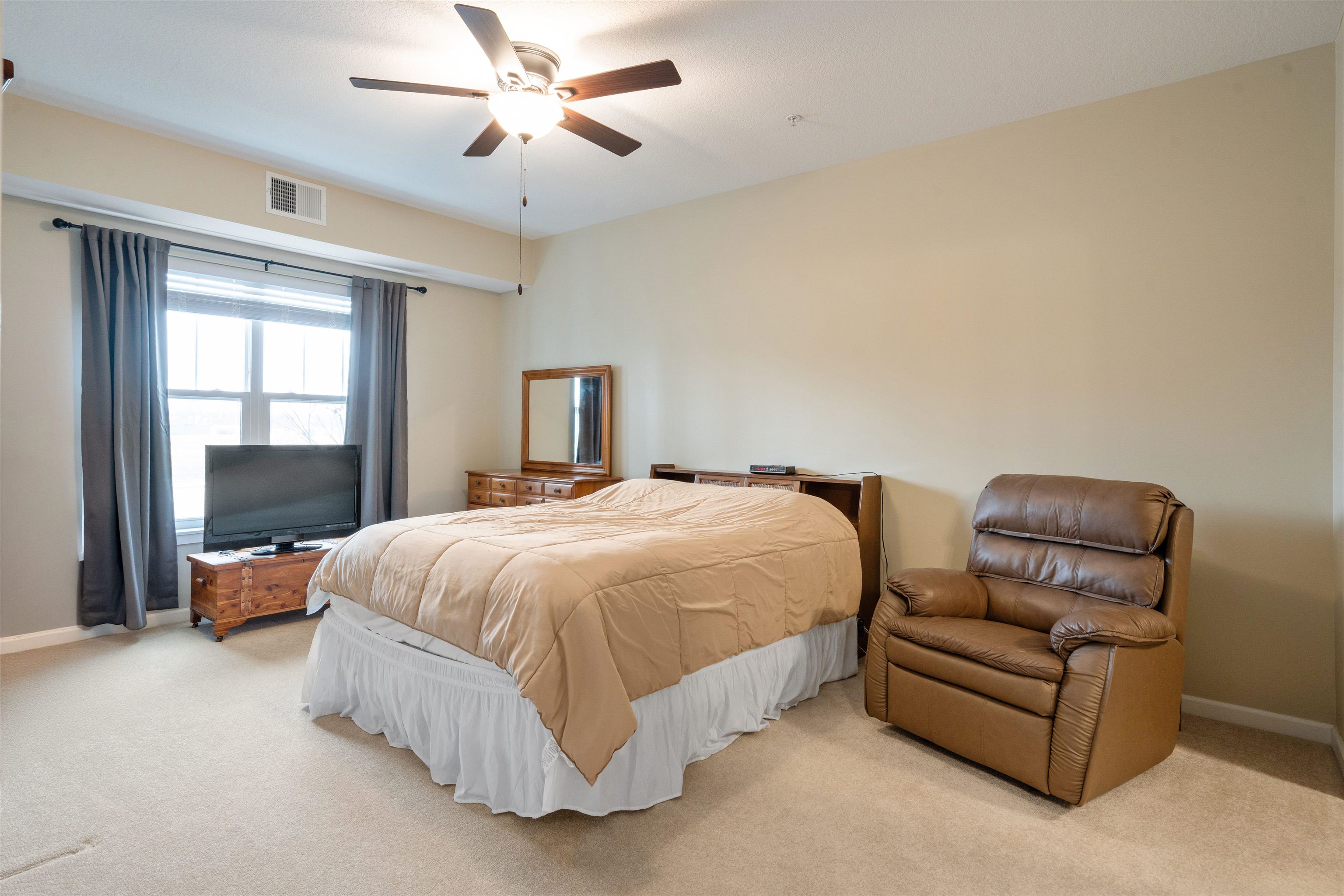 2592 Middle Road, Unit 208 Bettendorf, IA 52722 - Photo 10 of 19 a spacious bedroom with a bed and window