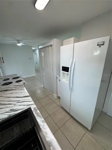 a kitchen with a stove a refrigerator and a sink