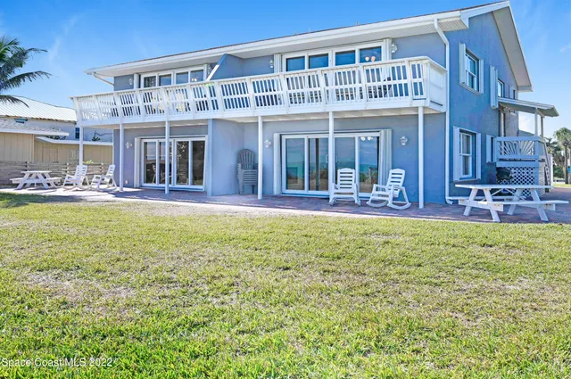 a kitchen with a dining table chairs and refrigerator