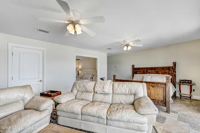a bathroom with a granite countertop toilet a sink and a mirror