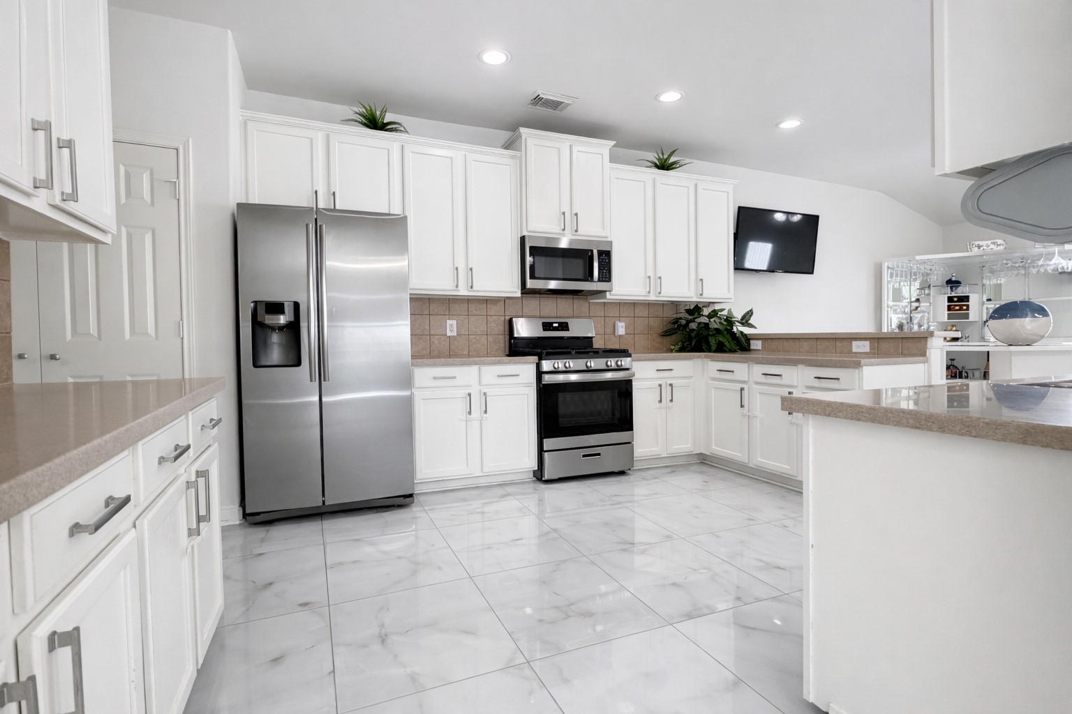 24534 Forest Path Court Spring, TX 77373 - Photo 14 of 43 a kitchen with granite countertop a refrigerator sink and wooden cabinets