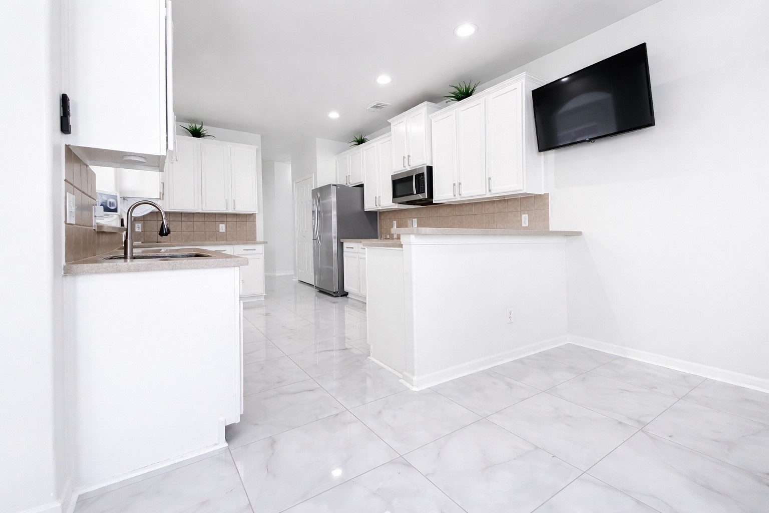 24534 Forest Path Court Spring, TX 77373 - Photo 16 of 43 a kitchen with kitchen island a sink stainless steel appliances and cabinets